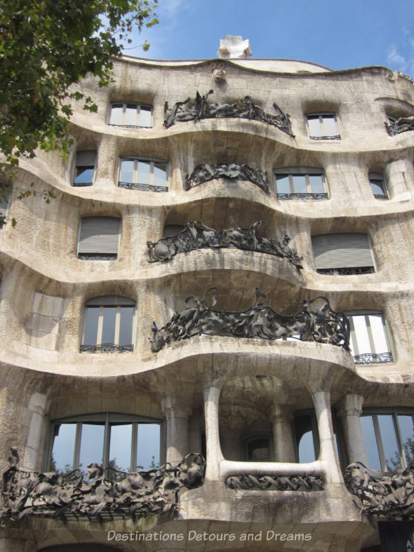 Balconies on the stone Casa Milà building with exquisite ironwork railings