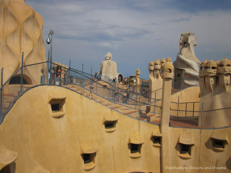 The undulating iconic rooftop of Casa Milà with it stone warriors and twisted chimneys