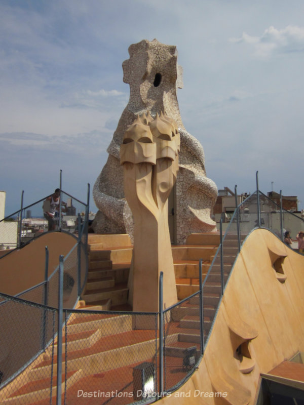 Twisted warrior rooftop chimneys and mosaic covered staircase at Cas Milà