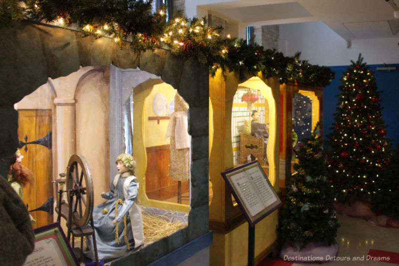 Fairytale vignettes in display cases (spinning girl from Rumpelstiltskin featured in foreground) as part of a Christmas display