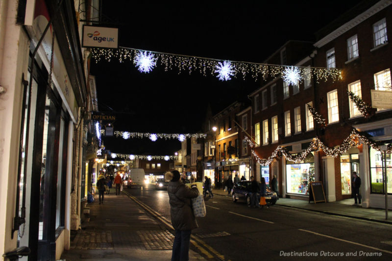 Garlands of Christmas lights strung across the street of an English town