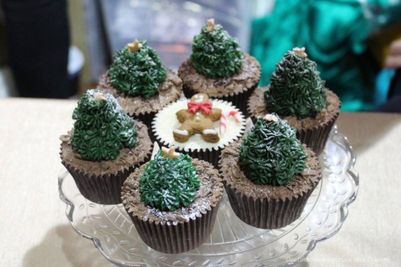 Chocolate cupcakes decorated with Christmas trees and a gingerbread man