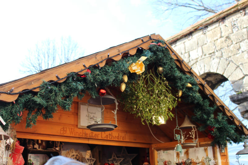 Garlands decorating the a-frame roof of wooden both at the Winchester Christmas Market