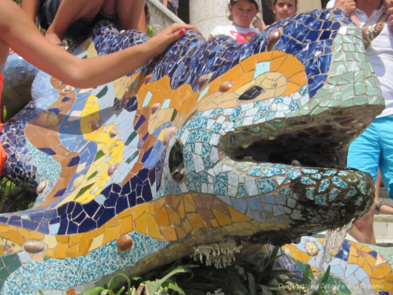 Figure of a dragon or salamander covered in a colouful mosaic of tiles at Park Güell