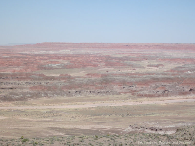 A vista in the Painted Desert showing pinks, reds, greens, and gray layers in the rock like colours brushed across a canvas