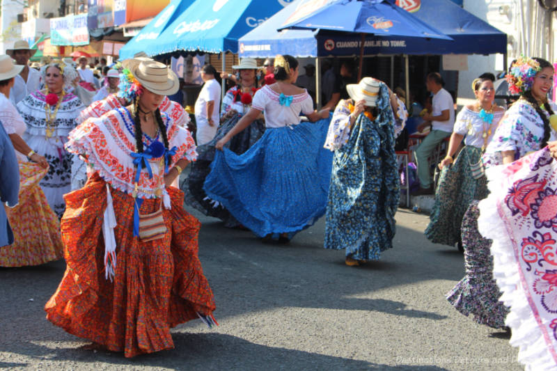 Woman in colourful polleras dancing in a street parade