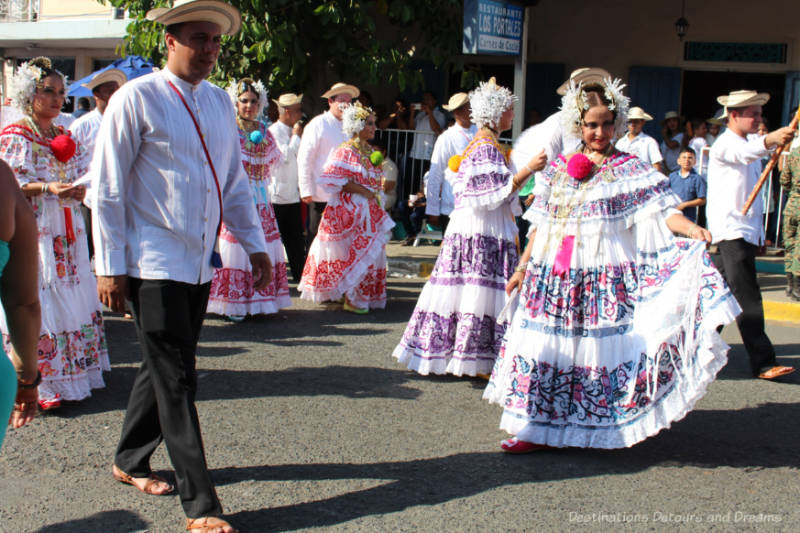 Women in pollera dresses and men in traditional attire parading in Las Tablas, Panama in the Parade of a Thousand Polleras