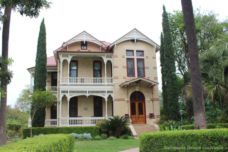 Victorian-style house constructed of yellow brick with red brick accents