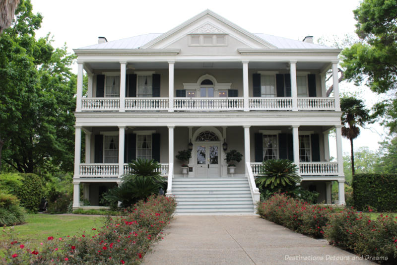 Two-story heritage white Mitchell-Oge House in San Antonio with wide front staircase and verandas on each level