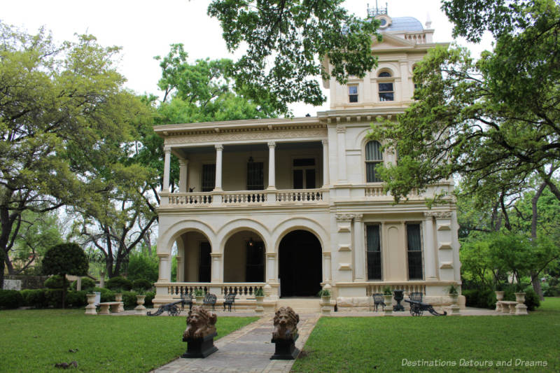 Elaborate two story heritage mansion with veranda and a three-story tower attached on the right