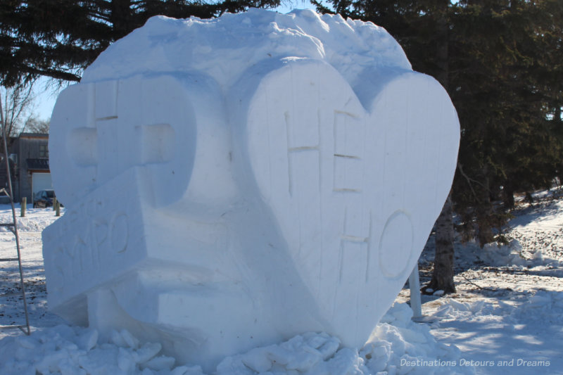 Snow sculpture with he ho written inside a heart, part of Festival du Voyageur