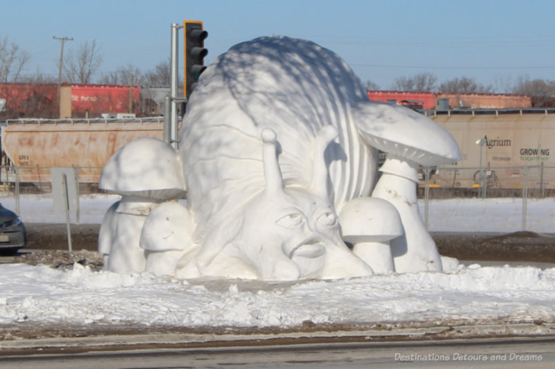 Snow sculpture of mushrooms and an ogre
