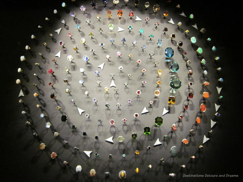 Rings set with different stones display in a series of concentric circles at the V&A