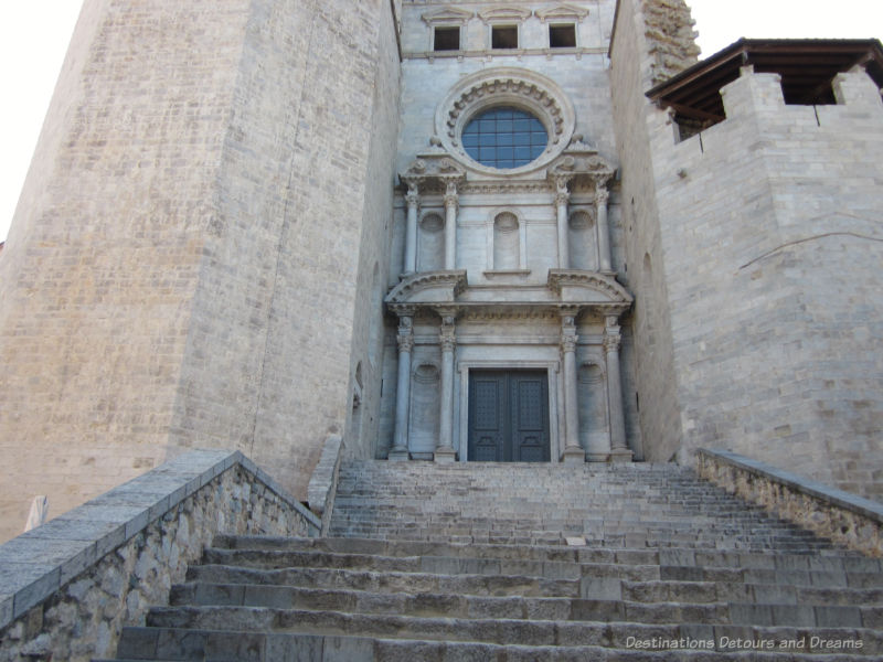 Stone Baroque front entrance of the Saint Feliu Basilic in Girona, Spain