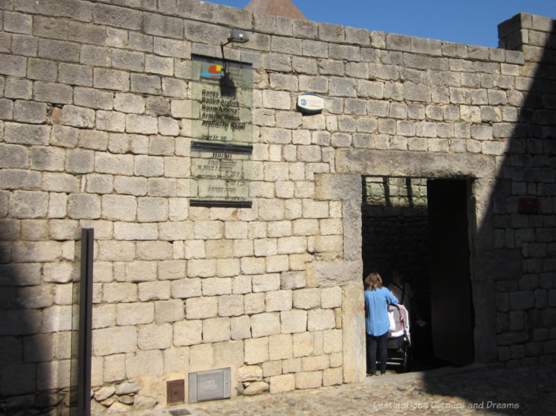 Stone wall and entrance to a 12th century Arab bath in Girona, Spain