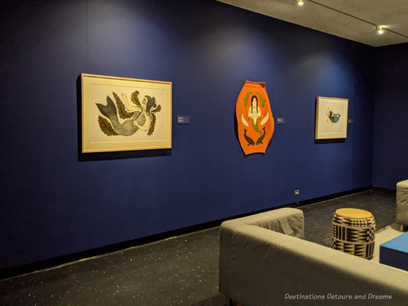 WAG Nuliajuk's Story Art gallery space with dark blue walls displaying Inuit art work at the Winnipeg Art Gallery