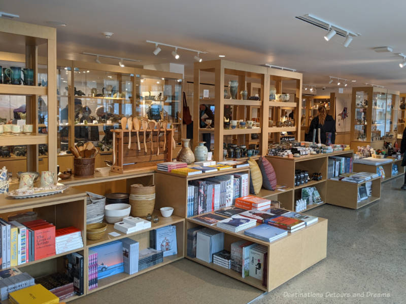 WAG Gift Shop Row of shelves in WAG art gallery shop contain books, cushions, pottery, Inuit carvings, and other gift items