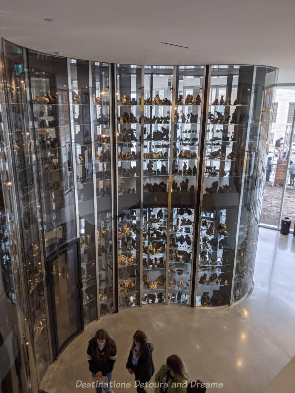 Qaumajq Visible Vault Three story Qaumajuq visible vault with undulating glass walls and glass shelves displaying Inuit carvings