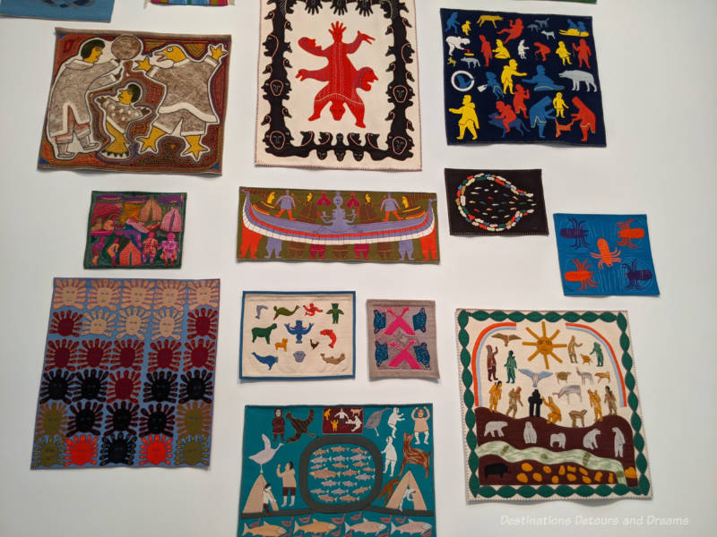 Qaumajuq Wall Hangings Collection of Inuit wall hangings hand-stitched with traditional images