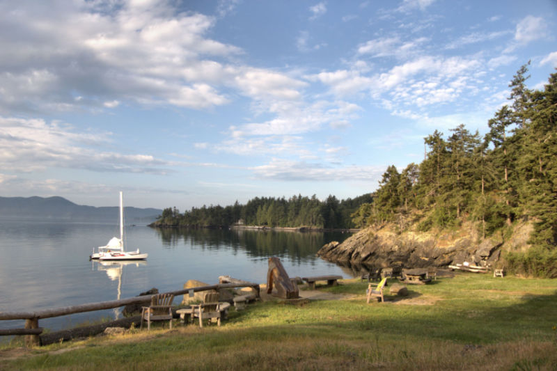 Rustic landscape and seating at water edge at Doe Bay Resort. Photo courtesy of San Juan Islands Visitors Bureau.