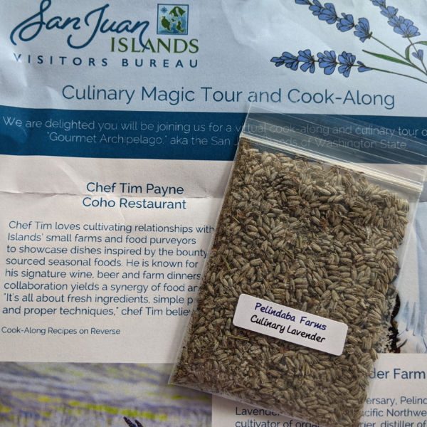 A small packet of culinary lavender from Pelindaba Farms on top of a cook-along brochure