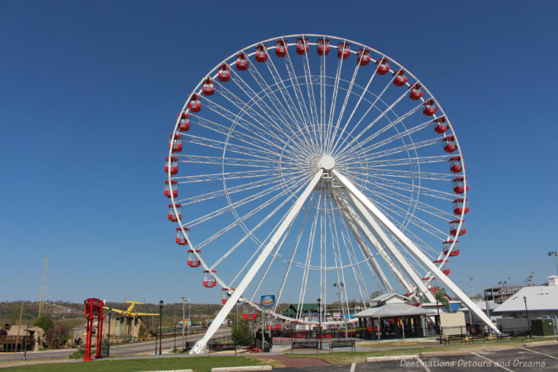 Branson Ferris Wheel Large white ferris wheel with red cars along the Branson Strip