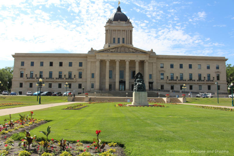 Beaux-Arts Classical Tyndall stone-covered Manitoba Legislative Building and the beautiful lawn in front of it