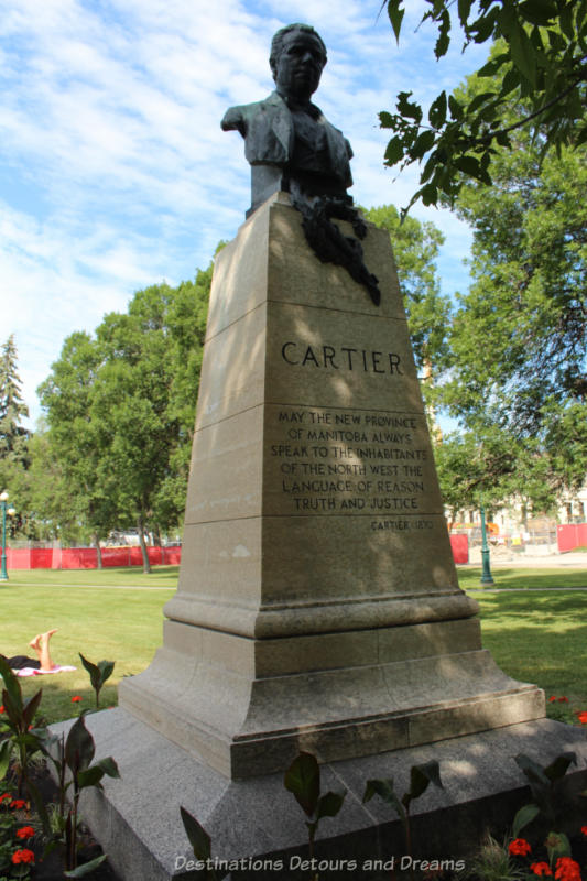 Bust of George Étienne Cartier atop a tall pedestal on the grounds of the Manitoba Legislative Building