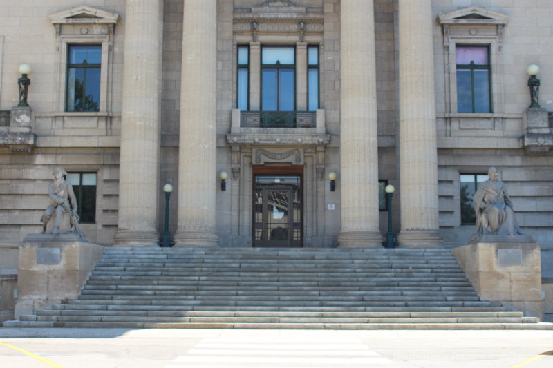 Tyndall limestone steps leading to the entrance of the Manitoba Legislative Building limestone building with round columns flanking the door