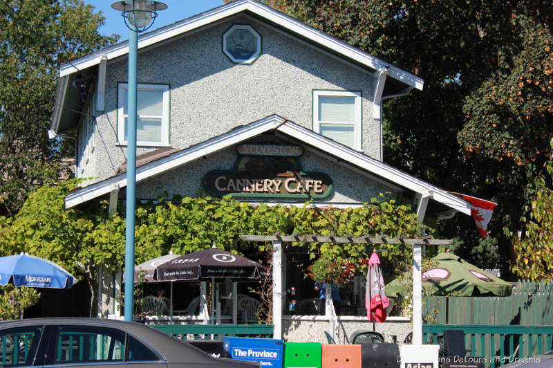 Vine covered cafe located in historic building with patio in front in Steveston, British Columbia