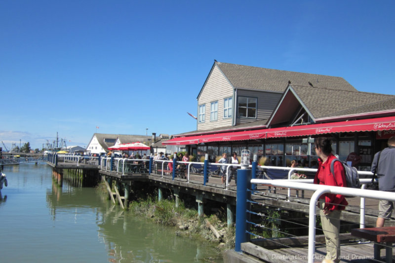 Waterfront boardwalk lined with restaurants in Steveston, British Columbia