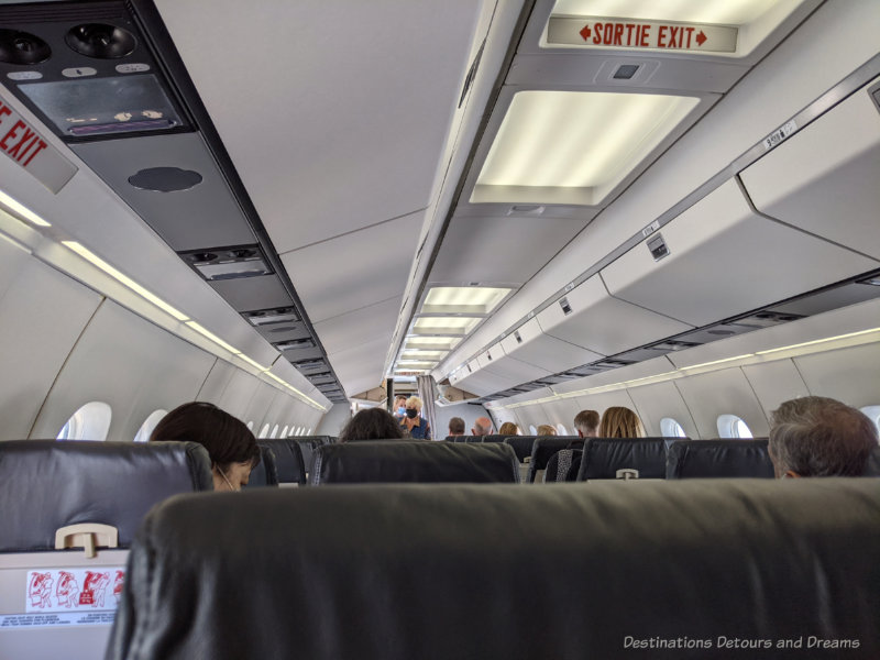 Inside the passenger cabin of an airplane as passengers board