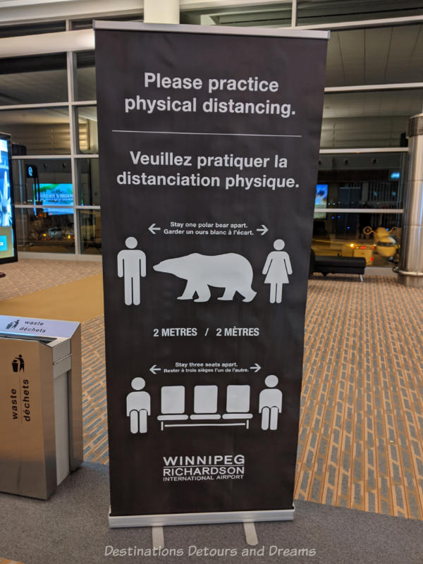 Physical distancing sign at airport showing to stay 3 seats or one polar bear apart