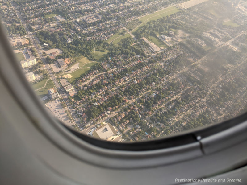 View of a city from the window of a plane - return to travel, what is it like?