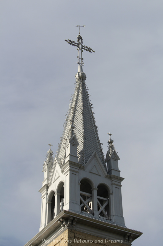 Metal steeple of an early 1900s French Catholic church in Canada