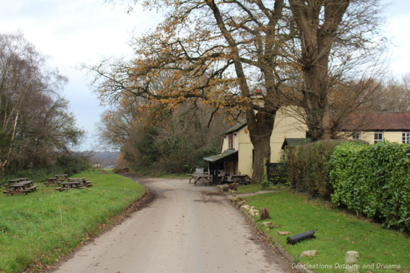 English country road leading to a pub housed in a 16th century royal hunting lodge