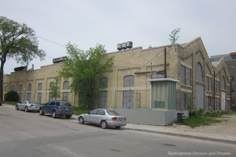 One story abandoned brick building with boarded-up windows, once the site of a historic pumping station in Winnipeg