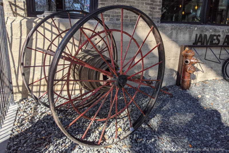 Antique fire host cart outside restaurant housed in a former pumping house