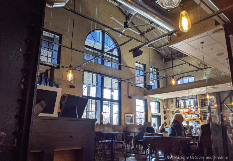 High ceilings , brick walls, tall windows in James Avenue Pumphouse restaurant