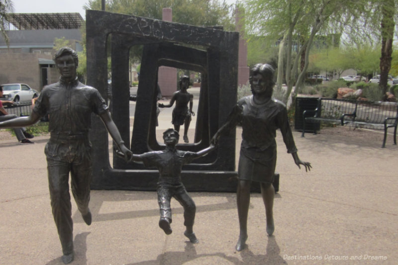 Set of bronze sculptures showing eight people in various stages of fighting cancer in Cancer Survivors Park in Phoenix