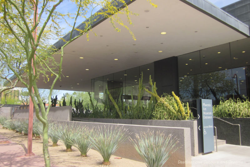 Covered entrance to the Phoenix Art Museum with plantings of desert plants