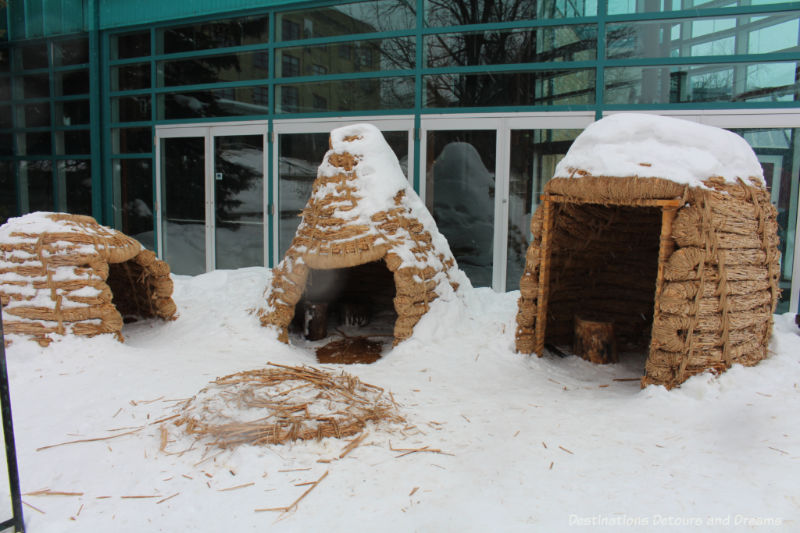 Three different shaped straw warming huts