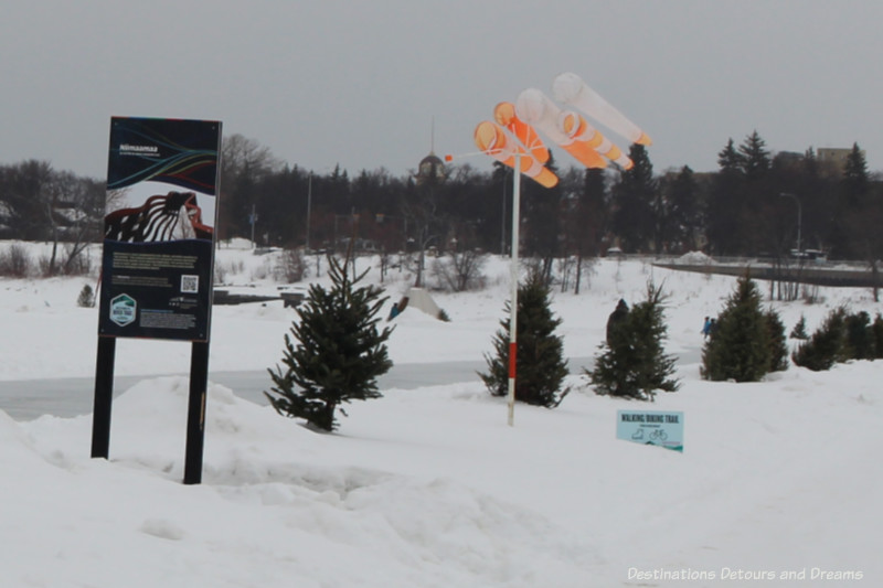 White and orange windsocks blowing along the river skating trail in Winnipeg,  Manitoba