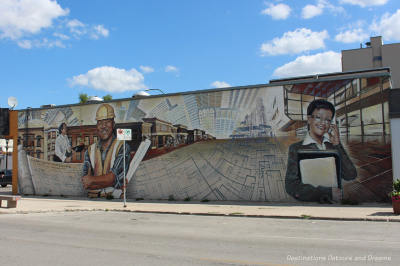 Mural on the side of a building features a collage of workers