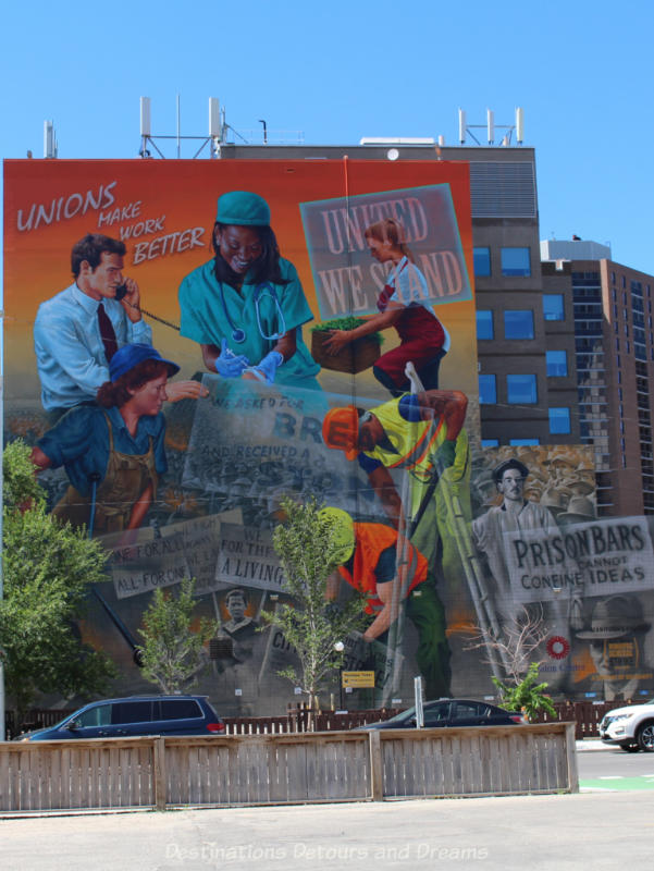 Large multi-story mural in Winnipeg dedicated to a century of worker solidarity shows a variety of workers: health care, construction, businessmen, and more