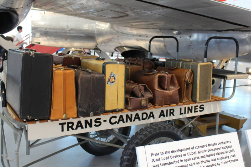 Old Trans-Canada luggage cart loaded with vintage luggage