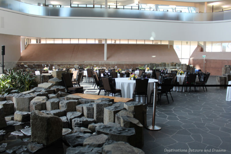 CMHR Garden of Contemplation with basalt rock and centre space set up with white-clothed tables for a function