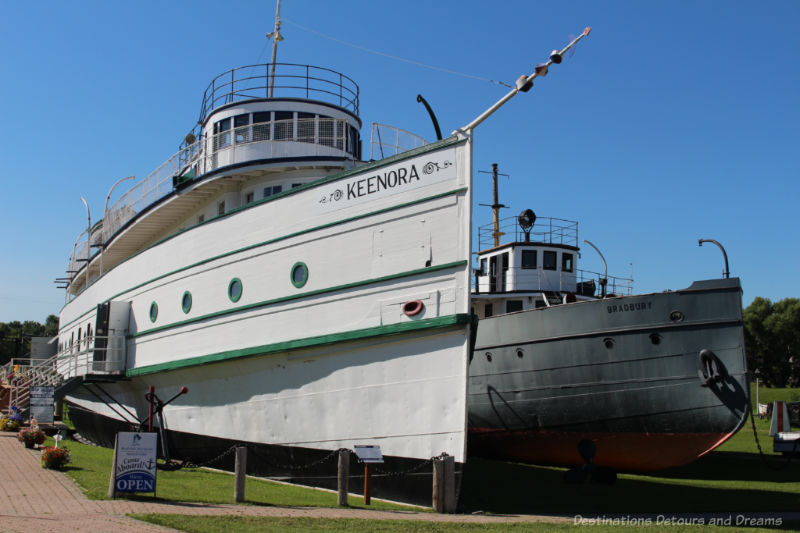 White passenger and freight steamboat with green trim 