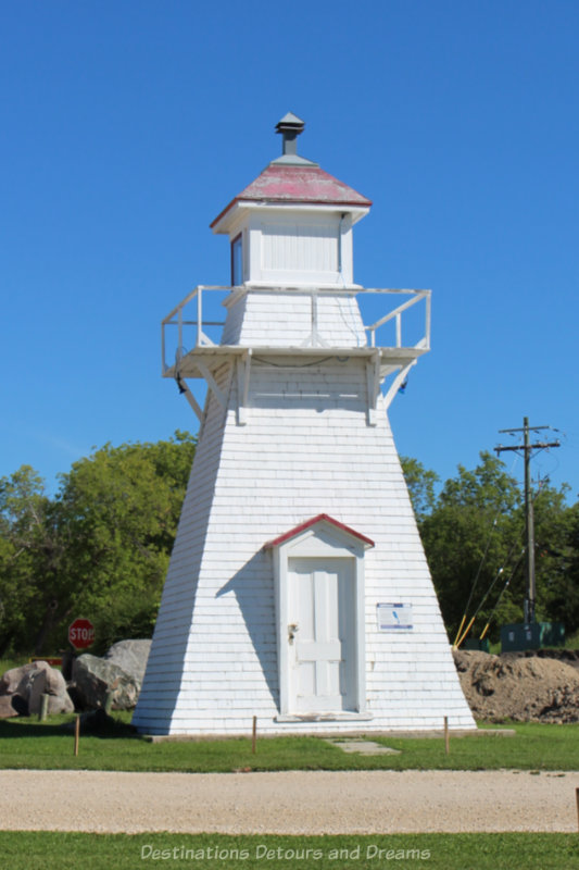 Wooden lake lighthouse painted white with red roof