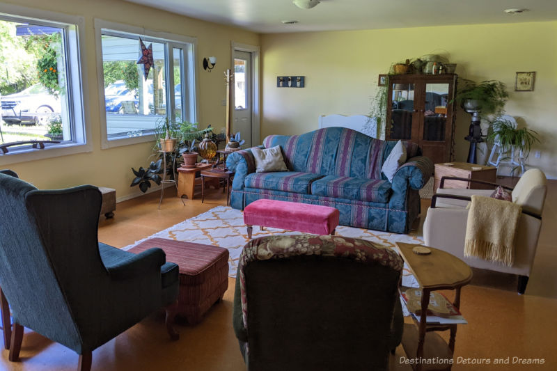 Moon Gate Common Area Sofa and comfortable chairs in a large sitting room with a windows letting in lots of light at Moon Gate Guest House